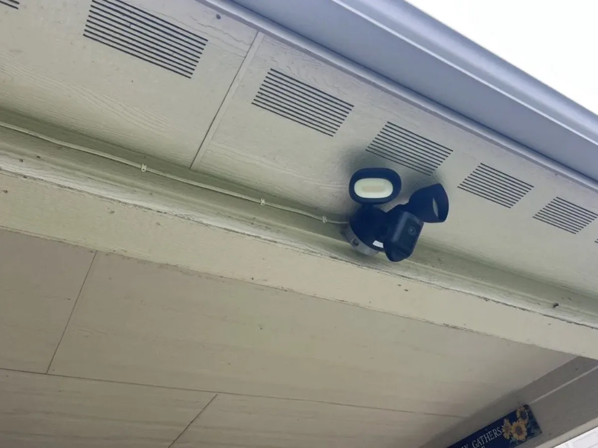 Ring floodlight security camera installed under a home's eave in Georgetown, TX